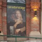 Canadian Stage poster in a window