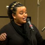 A woman sings gospel music