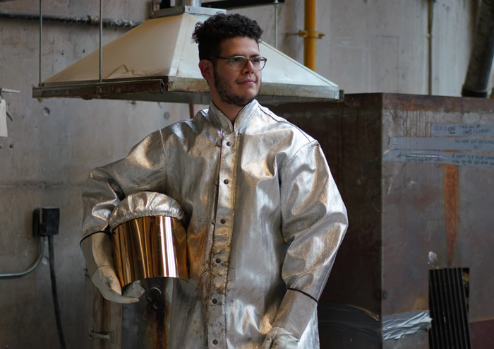 Moses Viveiros wears protective gear in the sculpture studio