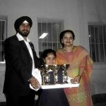 Gurharan Kaur as a child holding trophies with her mother and father