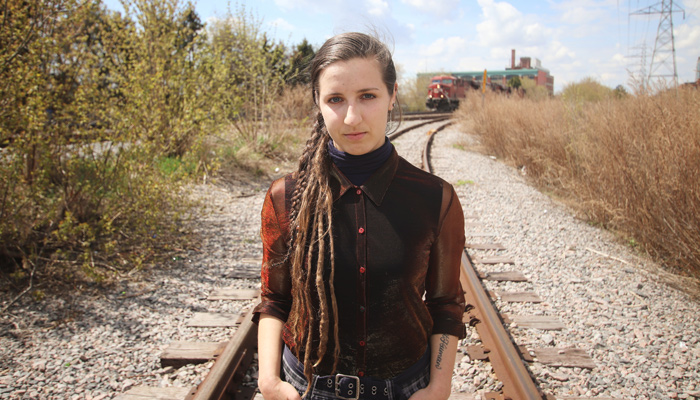 Sophie Dow stands on an abandoned railroad